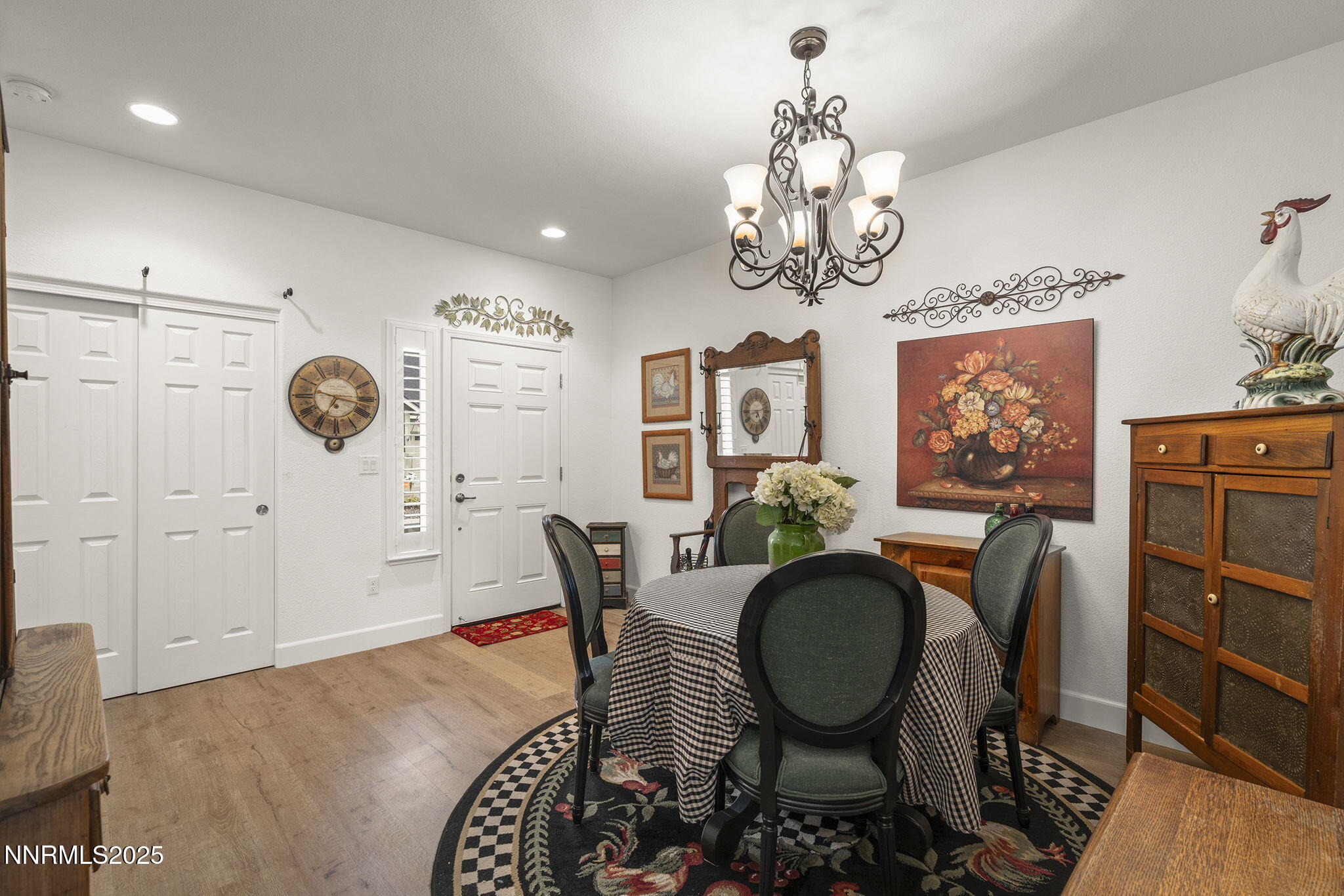 985 Floral Ridge Way Sparks, NV 89436 - Photo 6 of 24 a dining room with wooden floor a chandelier a wooden table and chairs