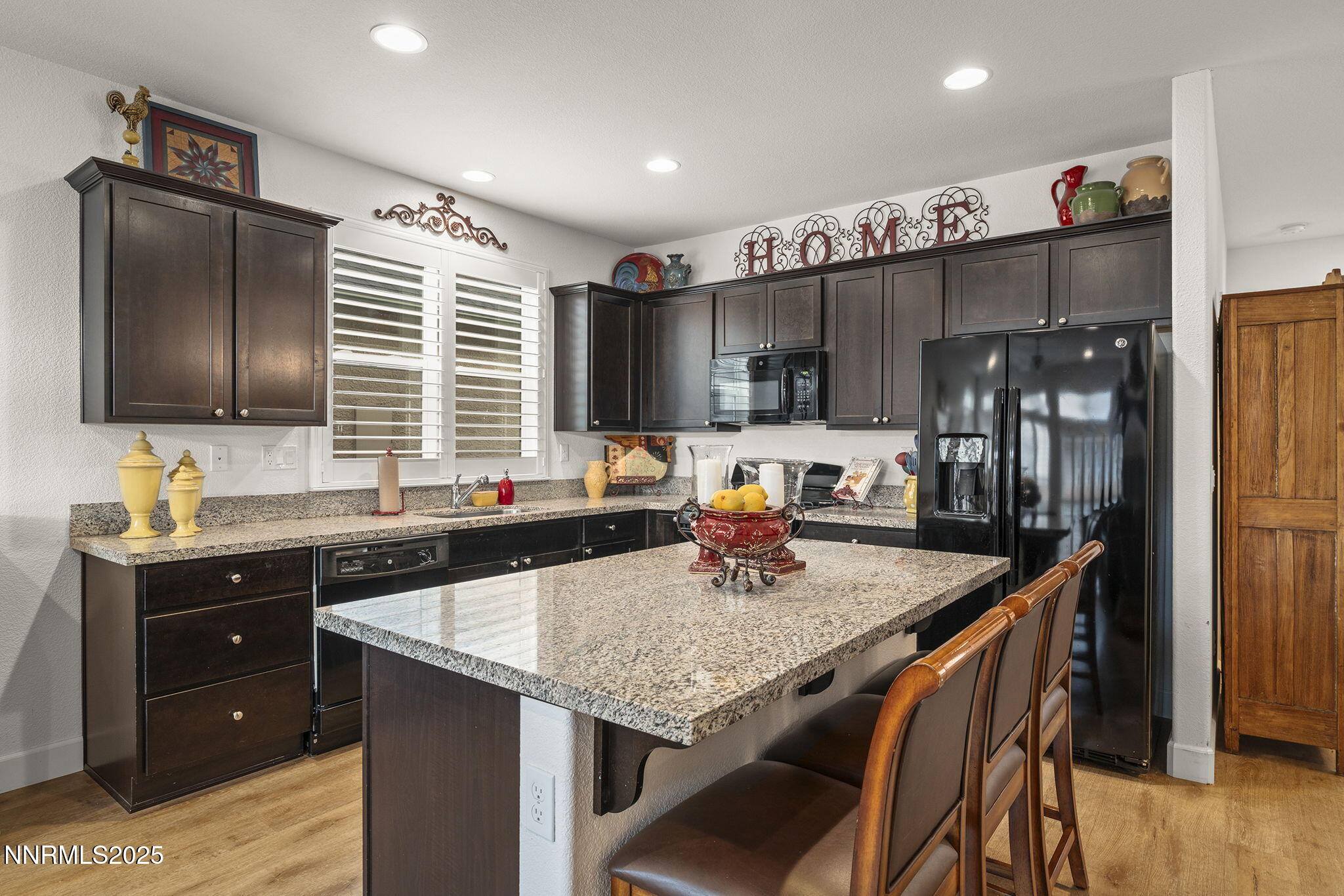 985 Floral Ridge Way Sparks, NV 89436 - Photo 9 of 24 a kitchen with granite countertop a sink counter space and stainless steel appliances