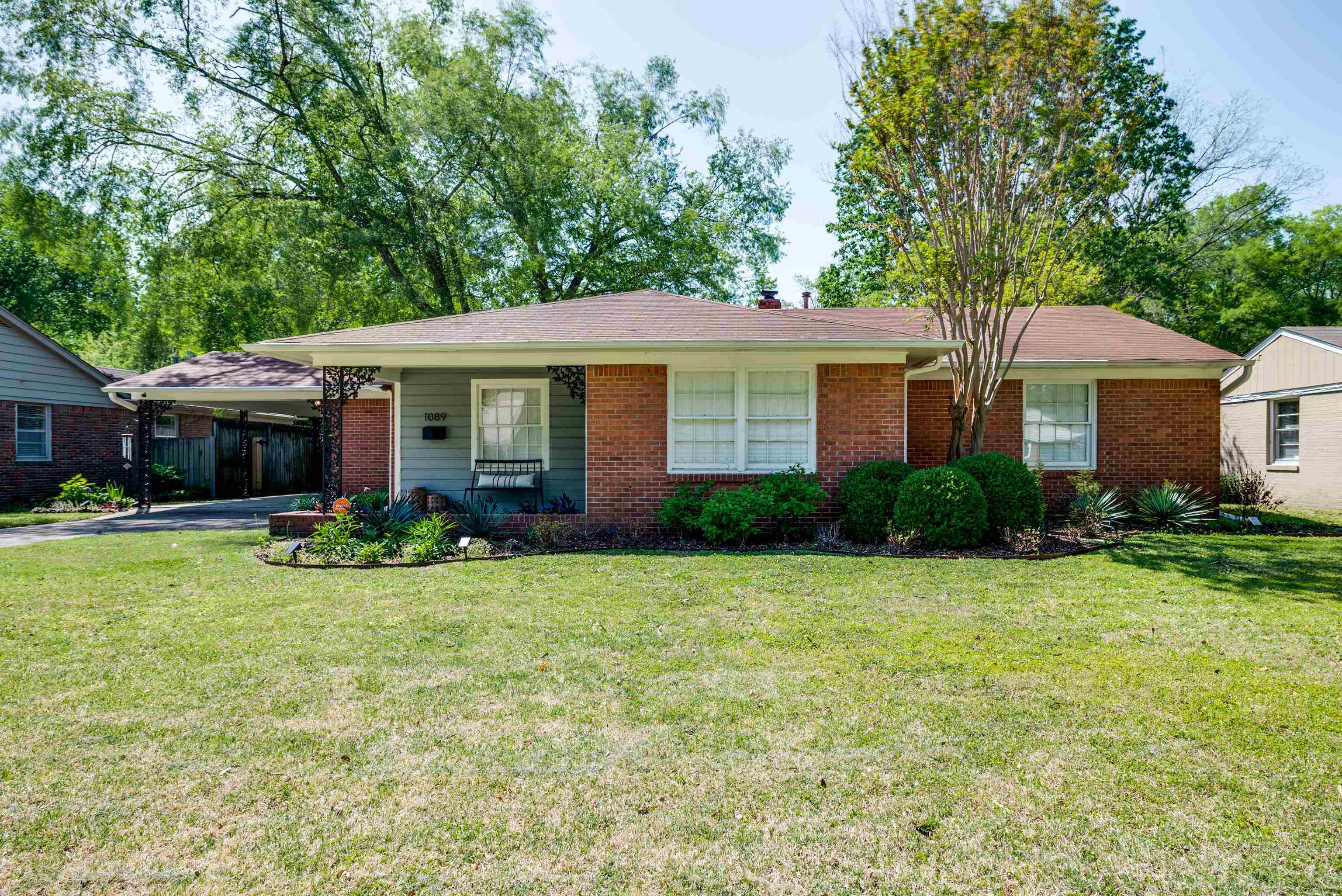 1089 West Perkins Road Memphis, TN 38117 - Photo 1 of 25 a front view of a house with a yard and porch