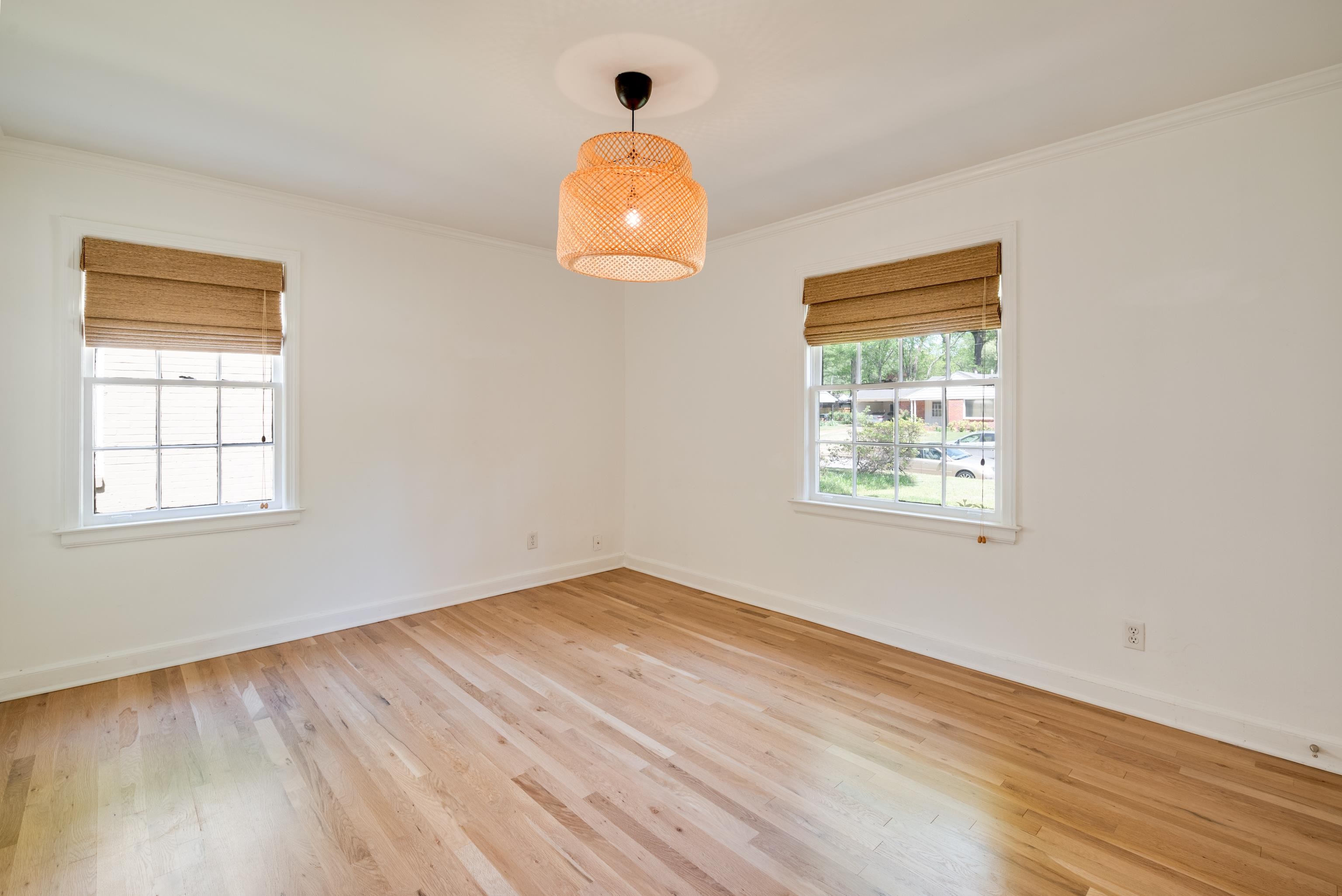 1089 West Perkins Road Memphis, TN 38117 - Photo 17 of 25 an empty room with wooden floor and windows