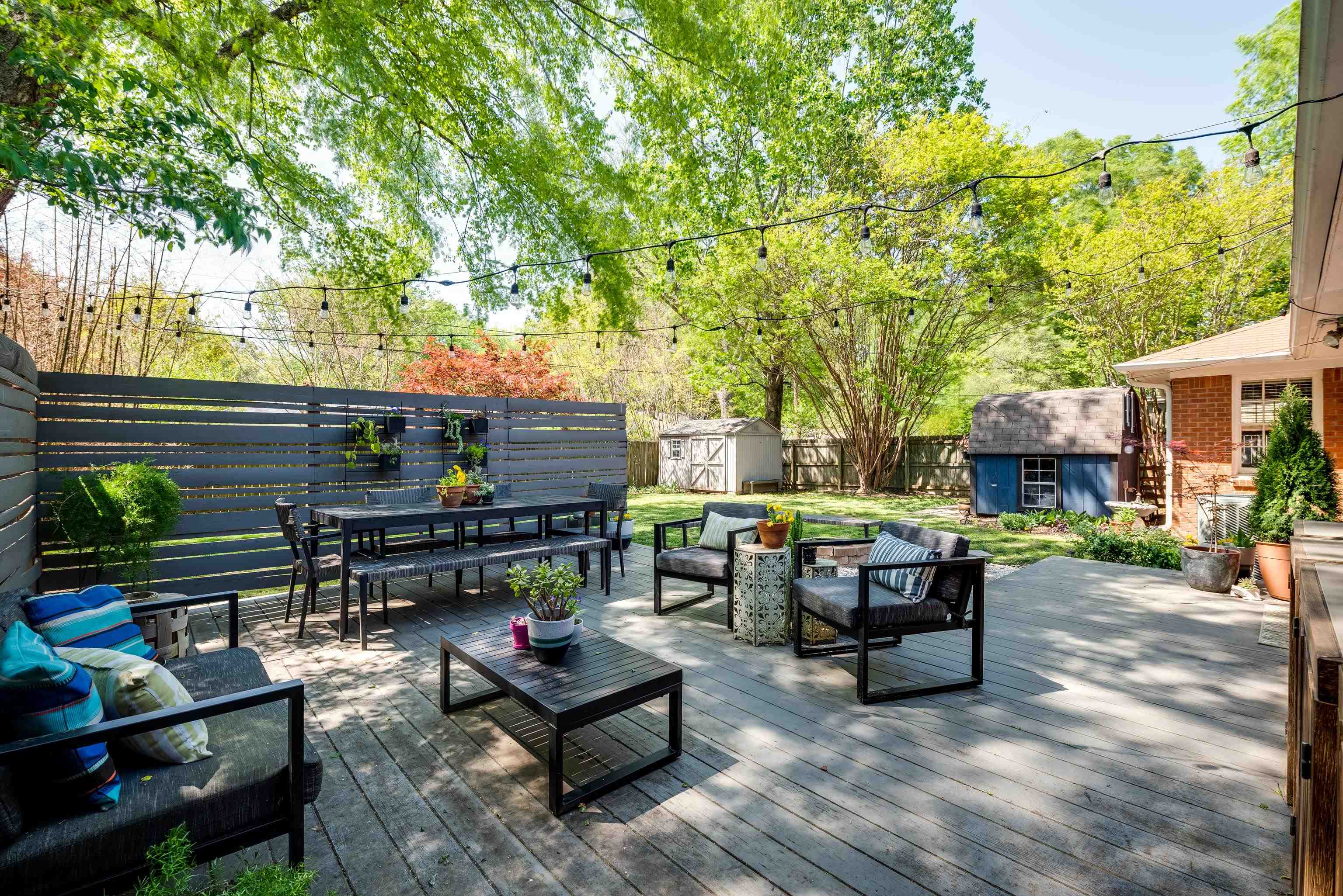 1089 West Perkins Road Memphis, TN 38117 - Photo 22 of 25 a view of a patio with couches and table and chairs with wooden fence and plants