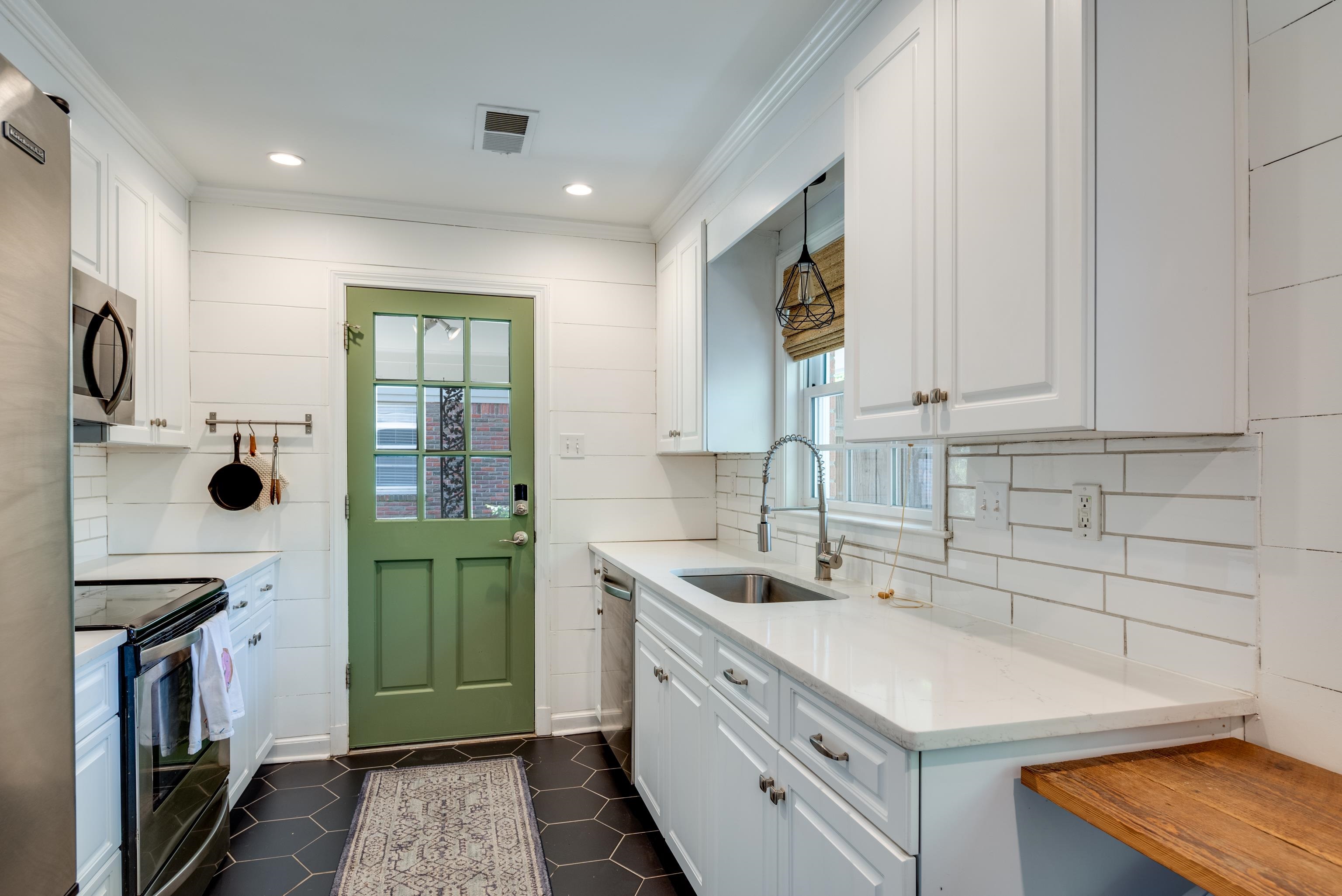 1089 West Perkins Road Memphis, TN 38117 - Photo 8 of 25 a kitchen with a sink cabinets and appliances