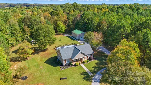 an aerial view of a house with yard swimming pool and outdoor seating