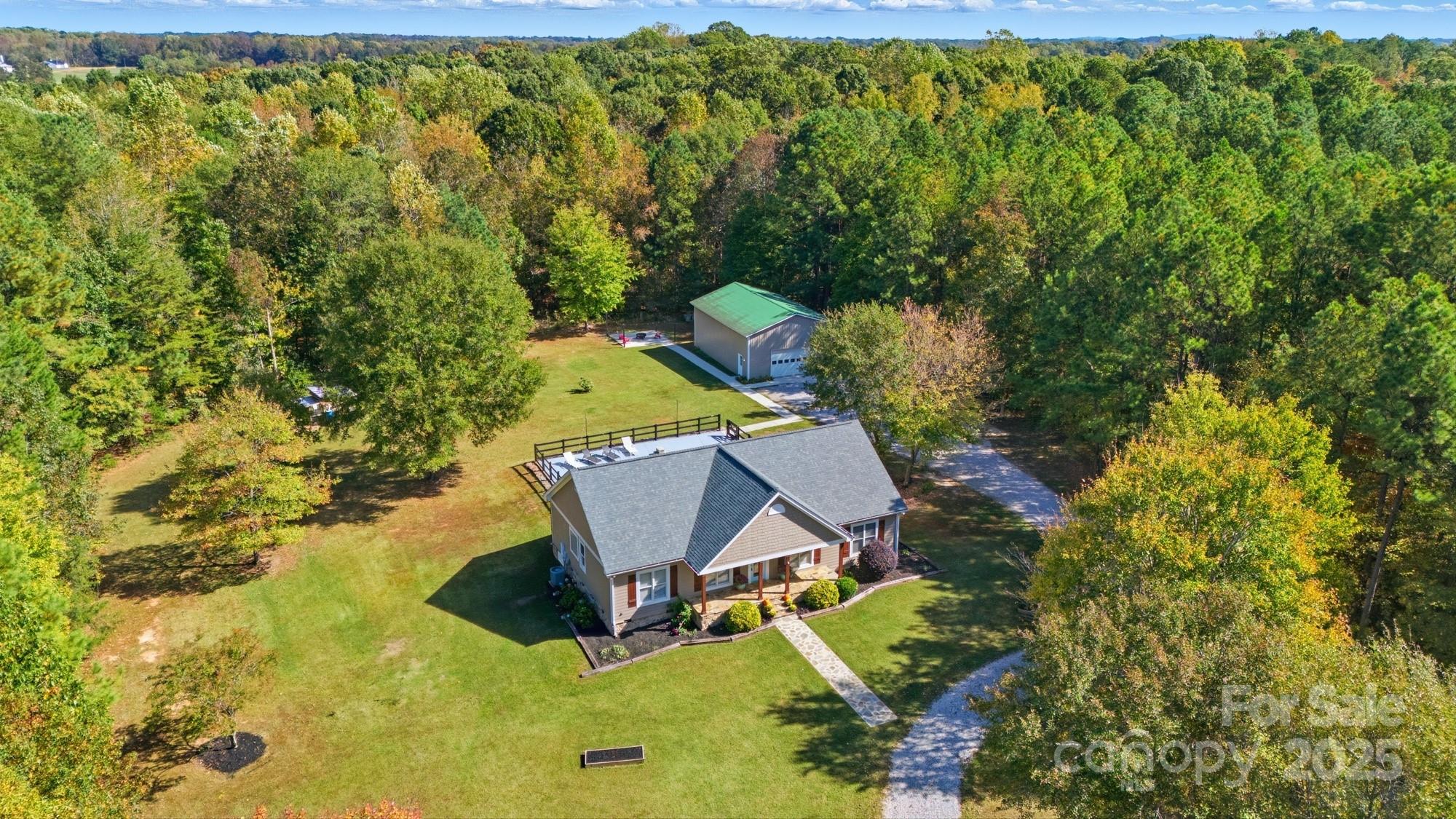 an aerial view of a house with yard swimming pool and outdoor seating