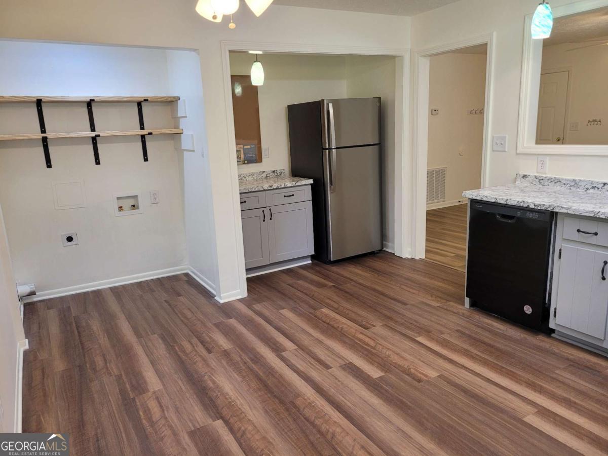 47 West New Street, Unit A Winder, GA 30680 - Photo 12 of 28 a view of kitchen with refrigerator cabinets and wooden floor