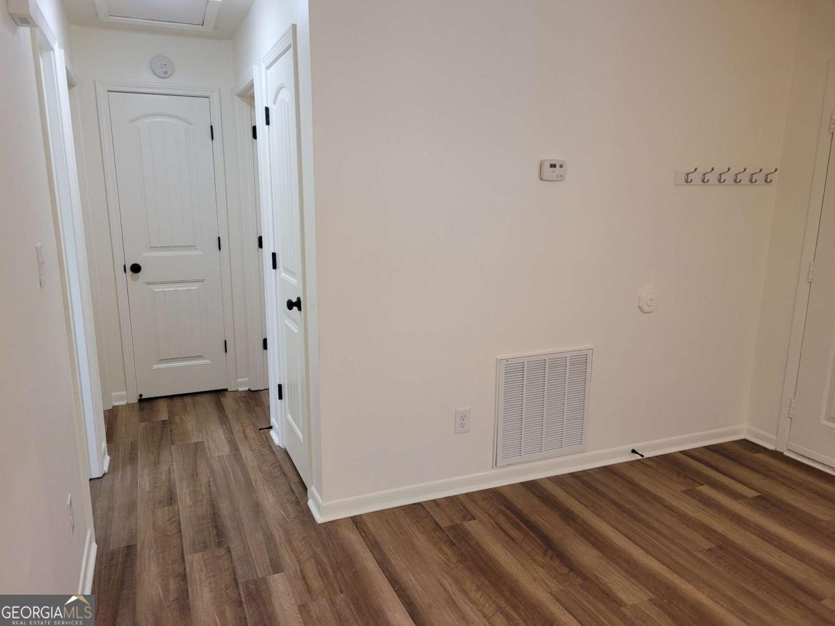 47 West New Street, Unit A Winder, GA 30680 - Photo 14 of 28 a view of a room with wooden floor and white doors