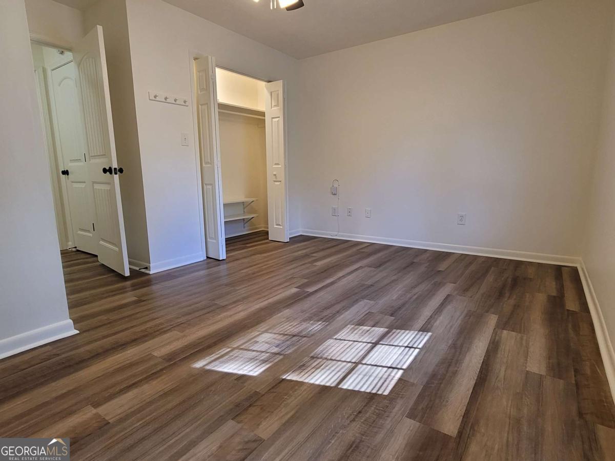47 West New Street, Unit A Winder, GA 30680 - Photo 18 of 28 an empty room with wooden floor and closet