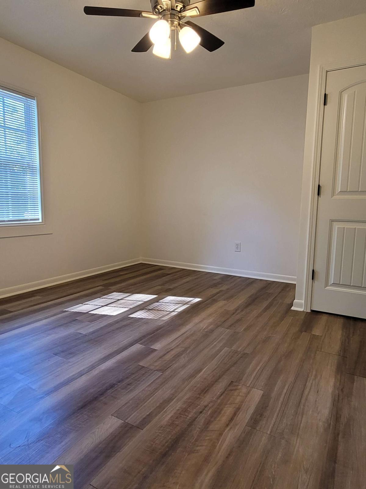 47 West New Street, Unit A Winder, GA 30680 - Photo 20 of 28 an empty room with wooden floor and windows
