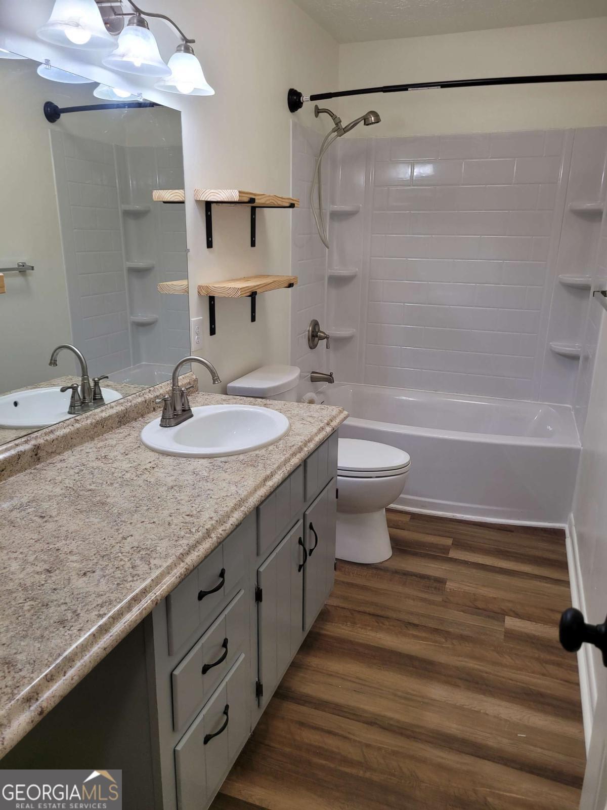47 West New Street, Unit A Winder, GA 30680 - Photo 22 of 28 a bathroom with a double vanity sink toilet and shower
