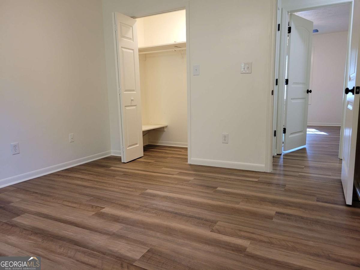 47 West New Street, Unit A Winder, GA 30680 - Photo 27 of 28 a view of a room with wooden floor and bathroom