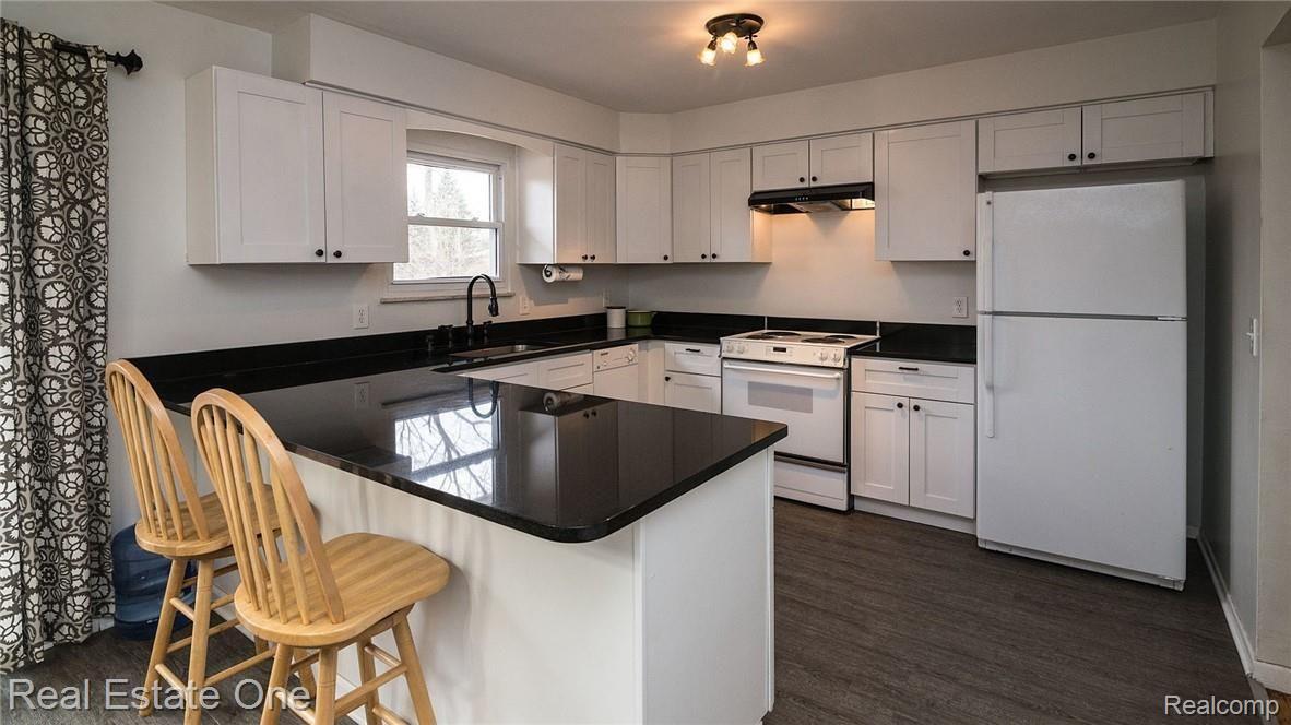 2655 Porter Road White Lake, MI 48383 - Photo 10 of 39 Large island features breakfast bar seating.