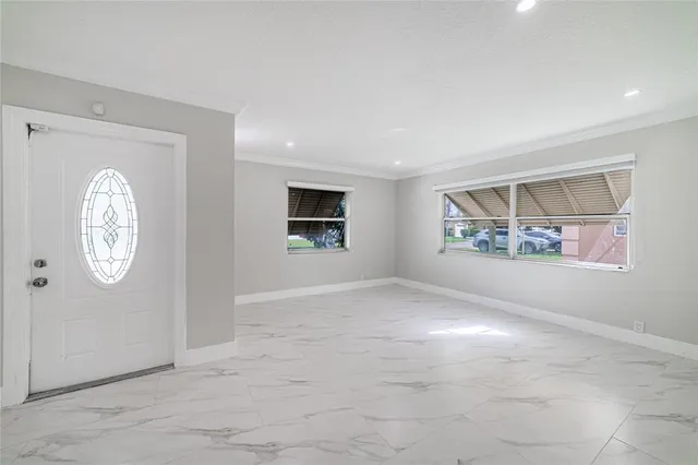 an empty room with wall painting and windows