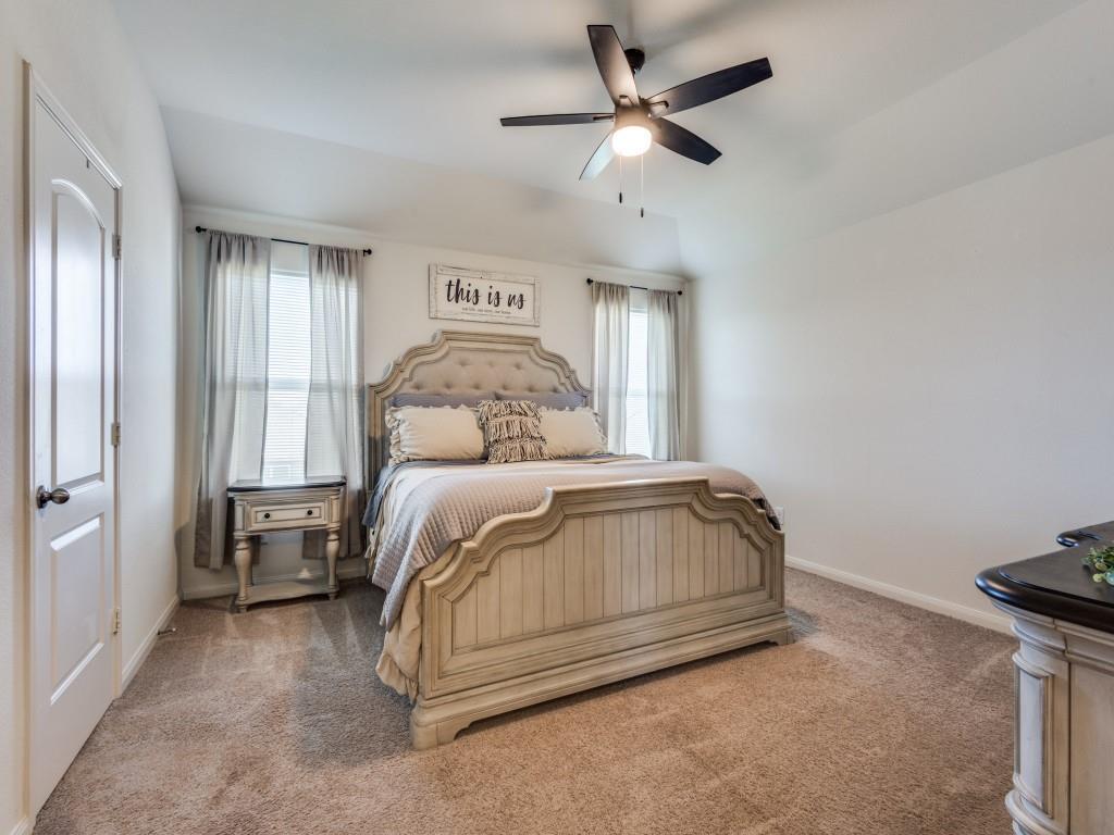157 Lamont Road Anna, TX 75409 - Photo 16 of 31 a bedroom with a bed and a chandelier