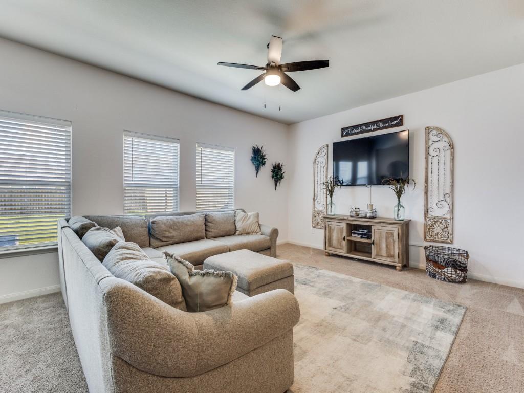 157 Lamont Road Anna, TX 75409 - Photo 7 of 31 a living room with furniture a fireplace and a flat screen tv