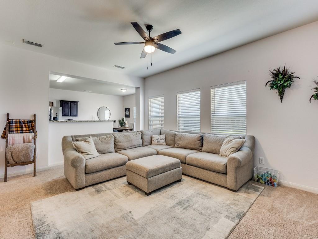 157 Lamont Road Anna, TX 75409 - Photo 8 of 31 a living room with furniture ceiling fan and a rug
