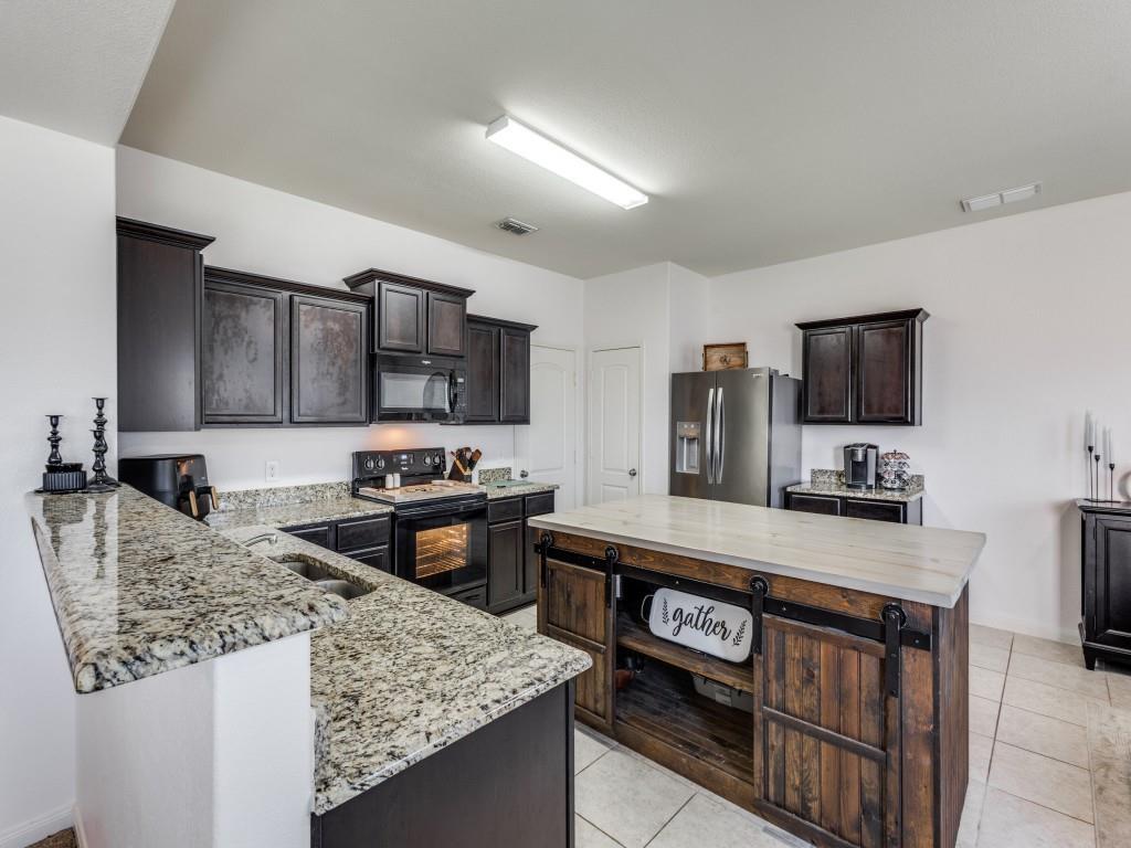 157 Lamont Road Anna, TX 75409 - Photo 10 of 31 a kitchen with stainless steel appliances granite countertop a sink stove and refrigerator