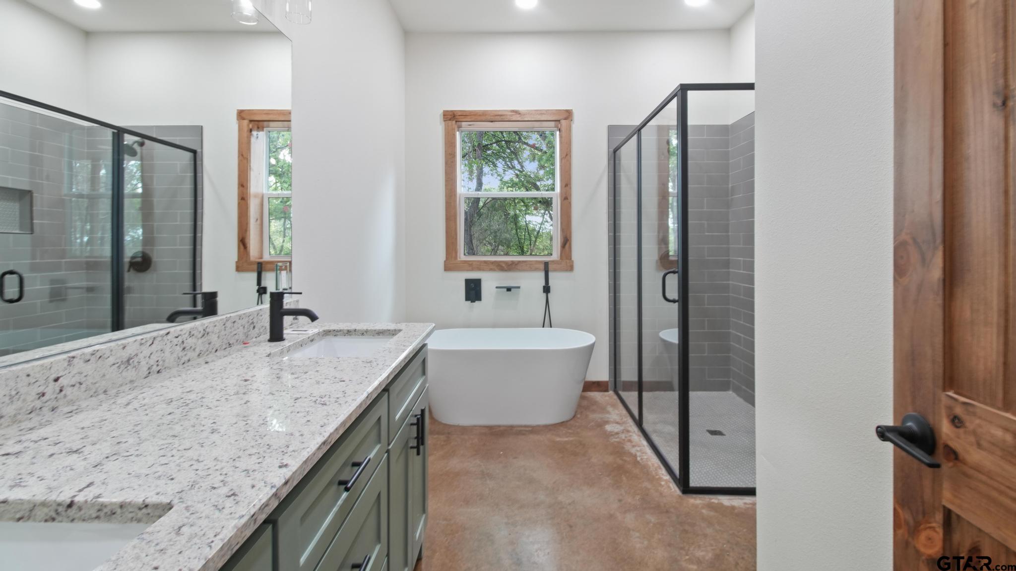 22522 Pine Street Flint, TX 75762 - Photo 16 of 39 a bathroom with a granite countertop sink a toilet and shower