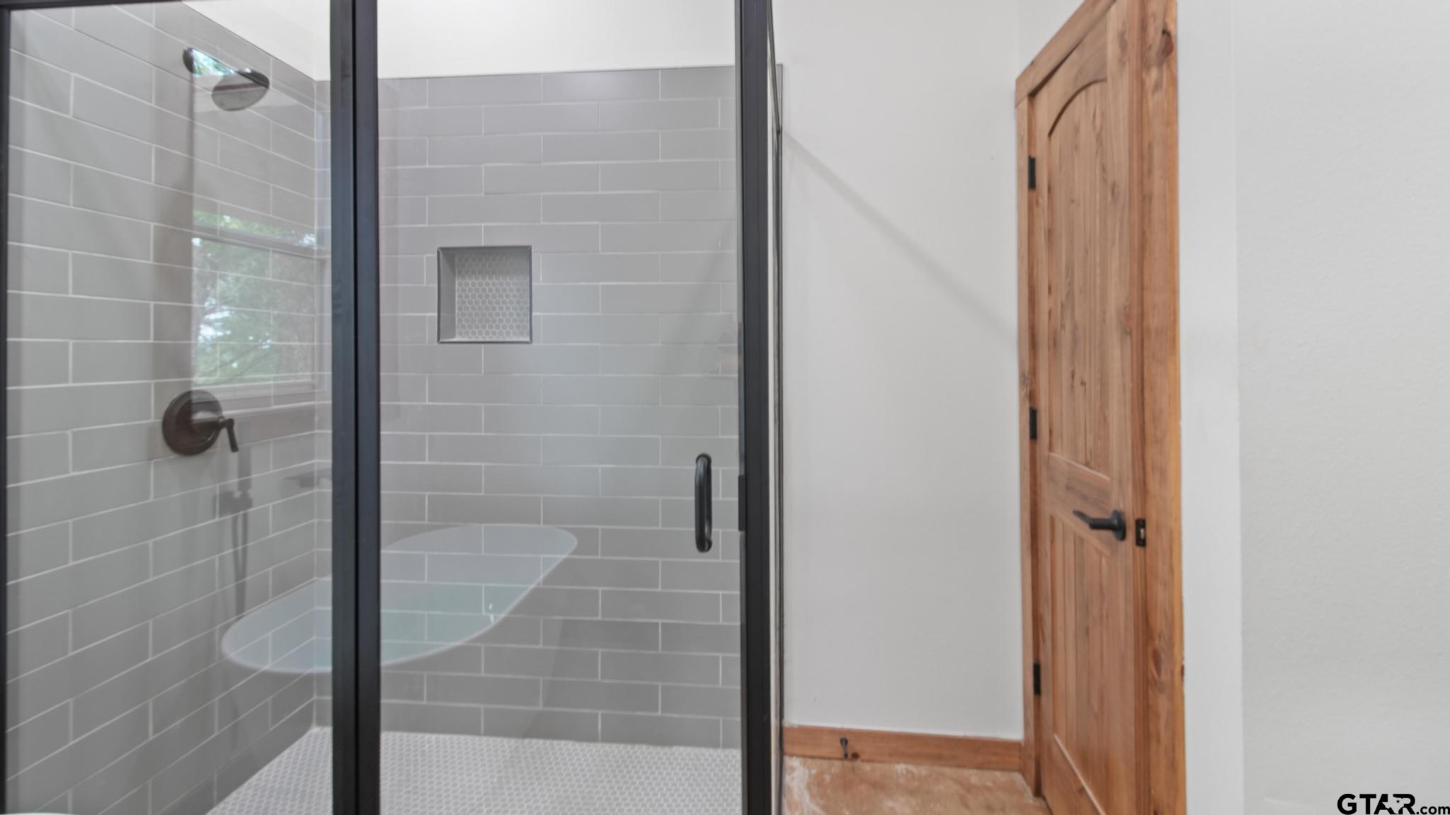 22522 Pine Street Flint, TX 75762 - Photo 18 of 39 a bathroom with a glass shower door