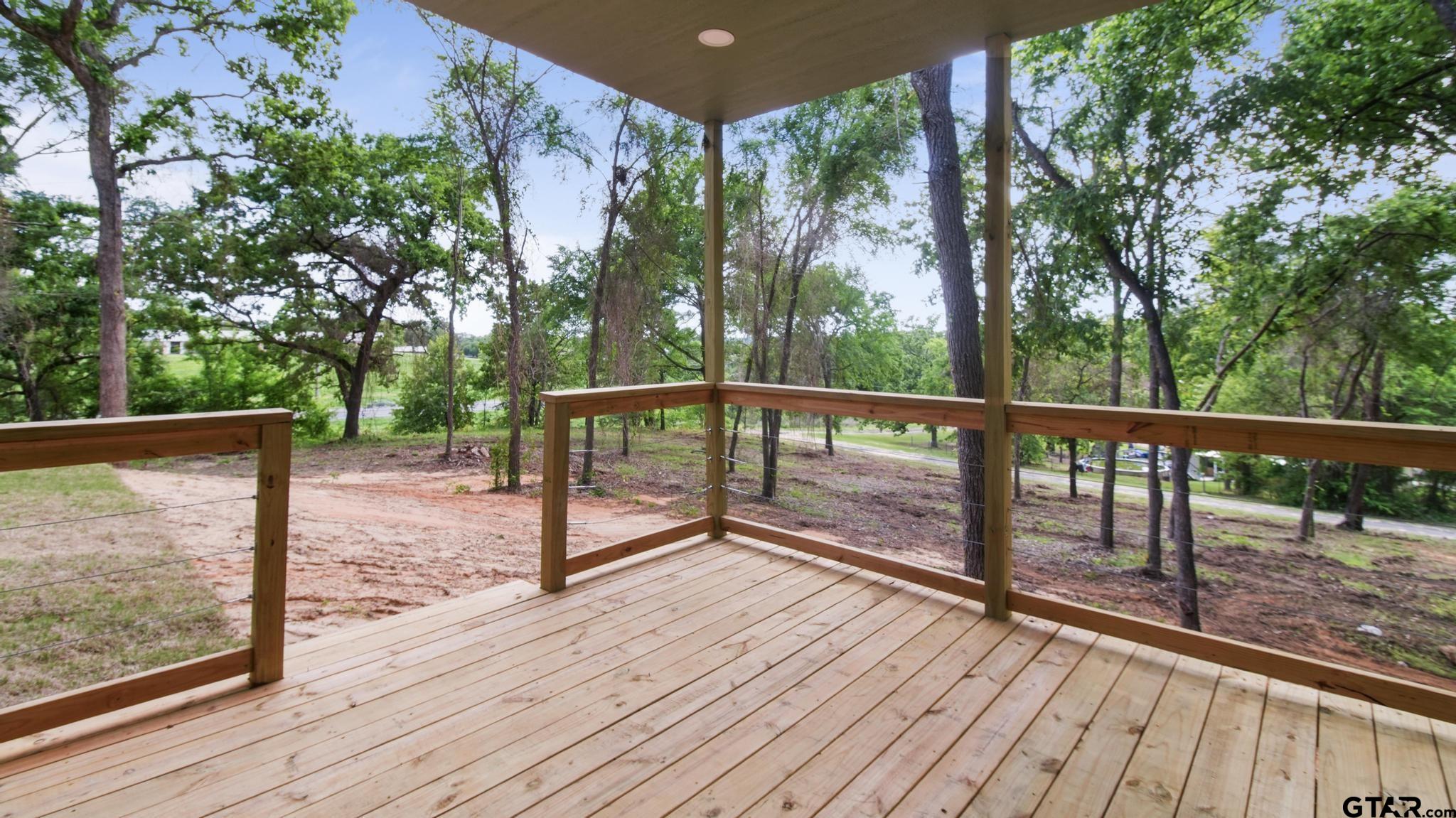 22522 Pine Street Flint, TX 75762 - Photo 30 of 39 a view of backyard with deck and wooden floor