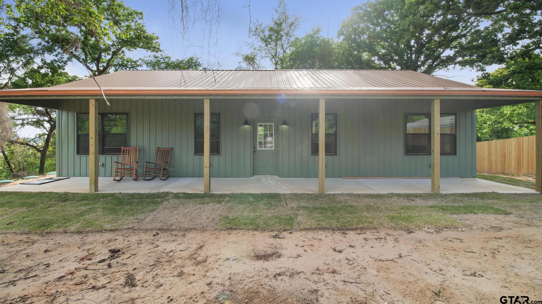 22522 Pine Street Flint, TX 75762 - Photo 3 of 39 a view of a house with a small yard and a large tree