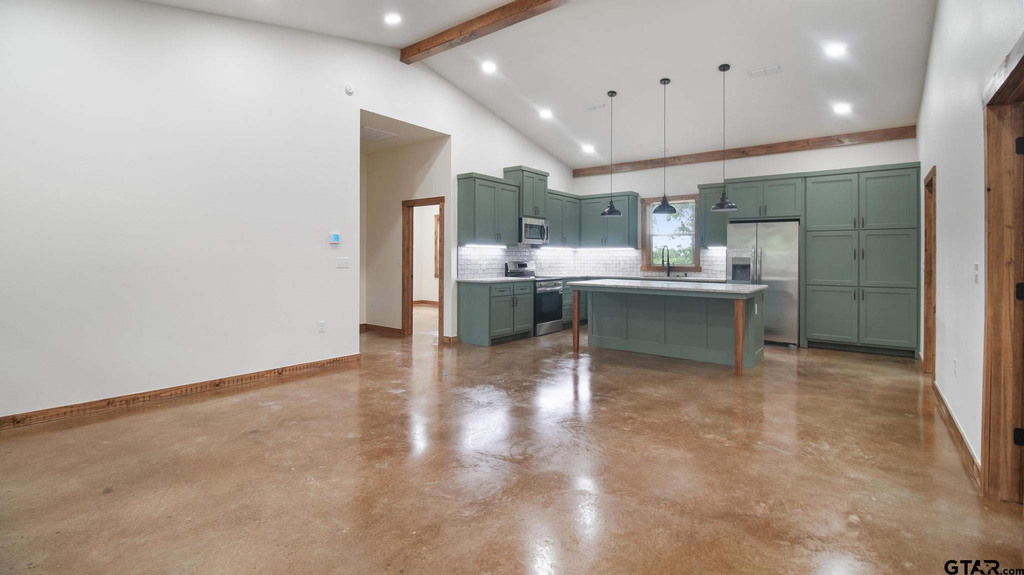 22522 Pine Street Flint, TX 75762 - Photo 7 of 39 a view of kitchen with kitchen island a sink wooden floor and chairs