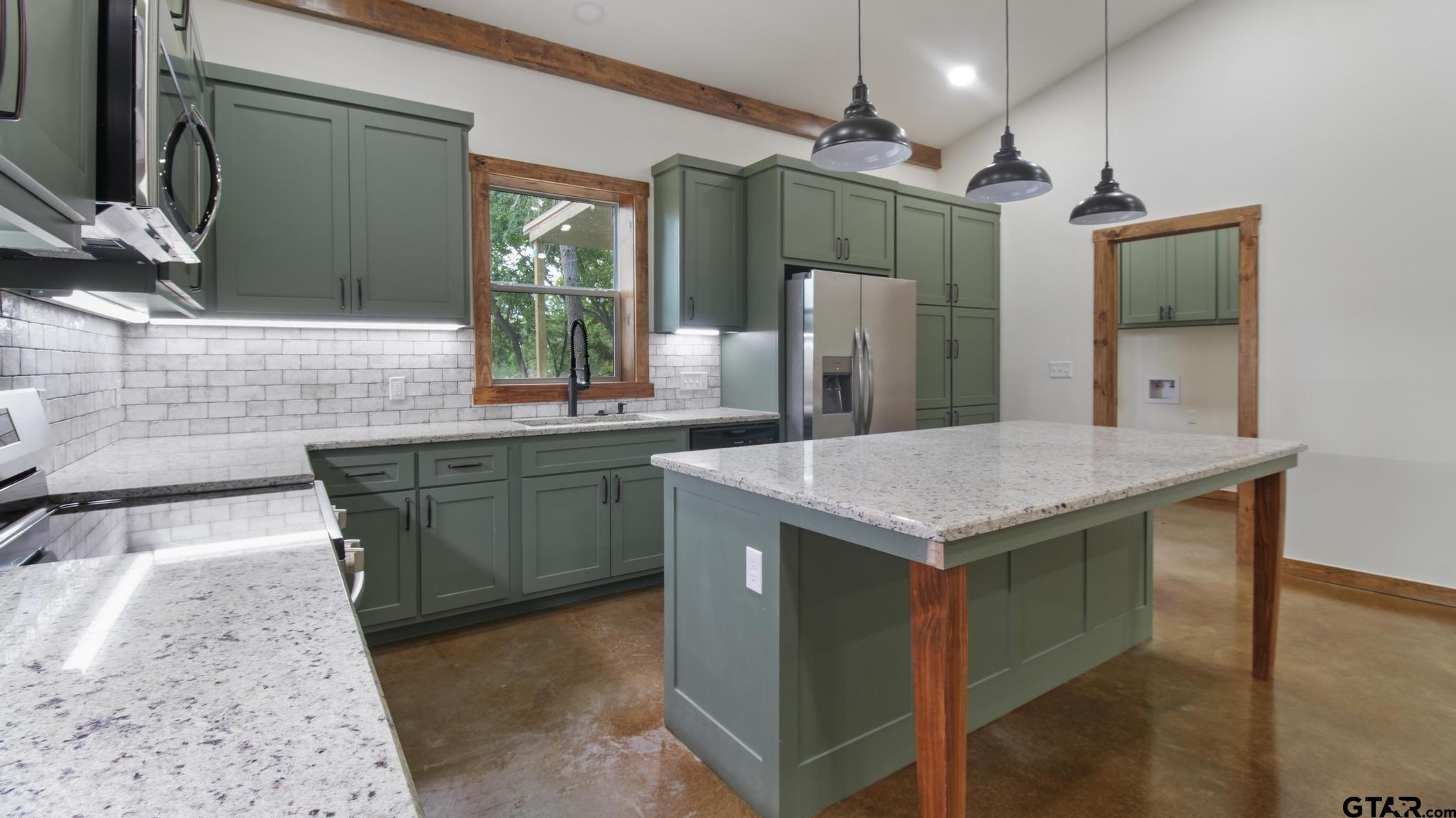 22522 Pine Street Flint, TX 75762 - Photo 9 of 39 a kitchen with a sink a counter space and stainless steel appliances