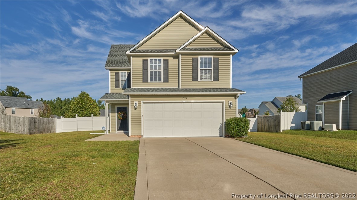 1913 Jenny Road Fayetteville, NC 28314 - Photo 1 of 38 a front view of a house with a yard and garage