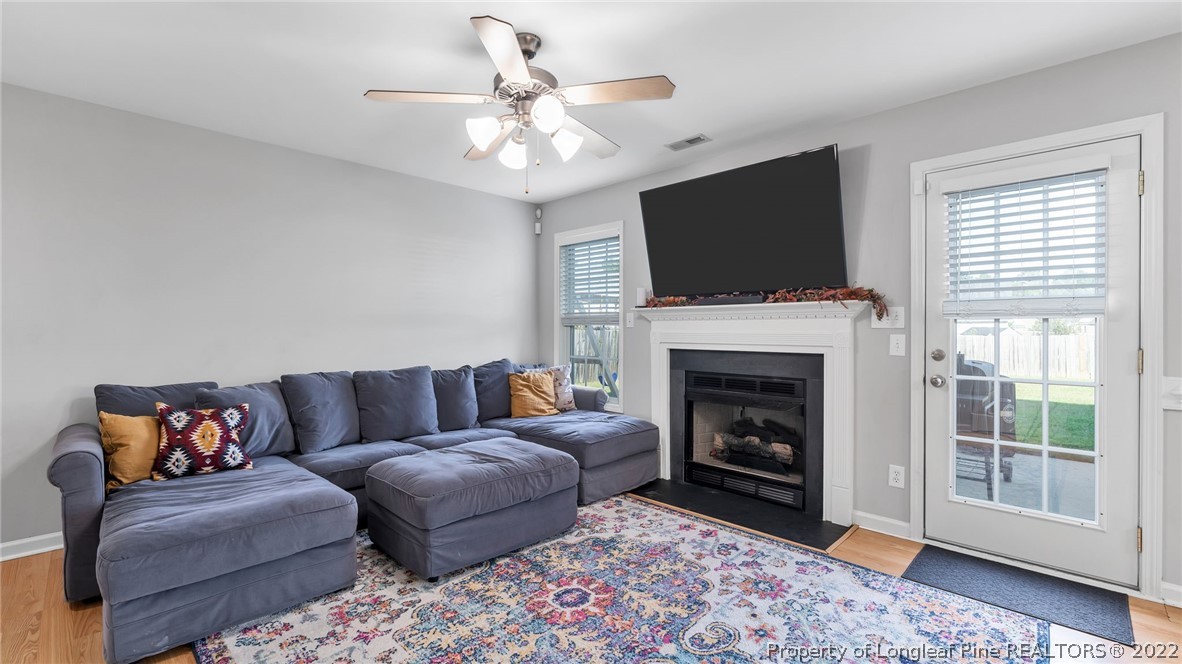 1913 Jenny Road Fayetteville, NC 28314 - Photo 11 of 38 a living room with furniture a flat screen tv and a fireplace