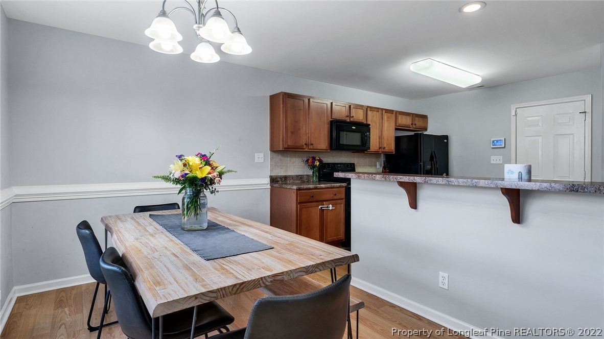 1913 Jenny Road Fayetteville, NC 28314 - Photo 15 of 38 a kitchen with a table chairs and a dining table