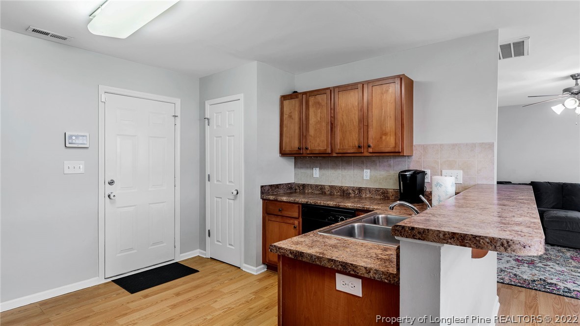 1913 Jenny Road Fayetteville, NC 28314 - Photo 17 of 38 a kitchen with kitchen island granite countertop wooden cabinets and a stove