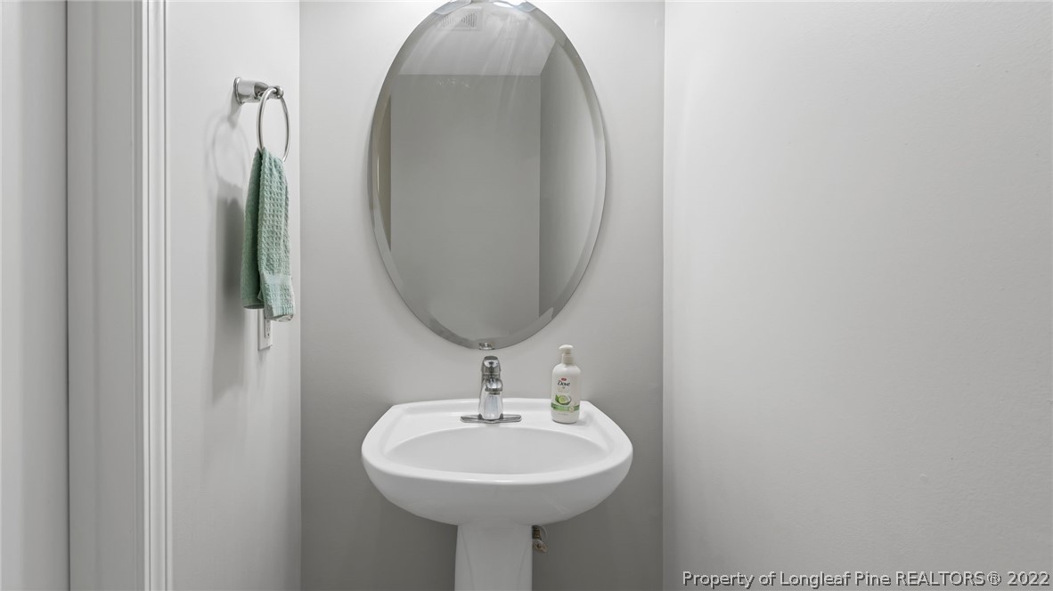 1913 Jenny Road Fayetteville, NC 28314 - Photo 20 of 38 a bathroom with a sink a mirror and vanity