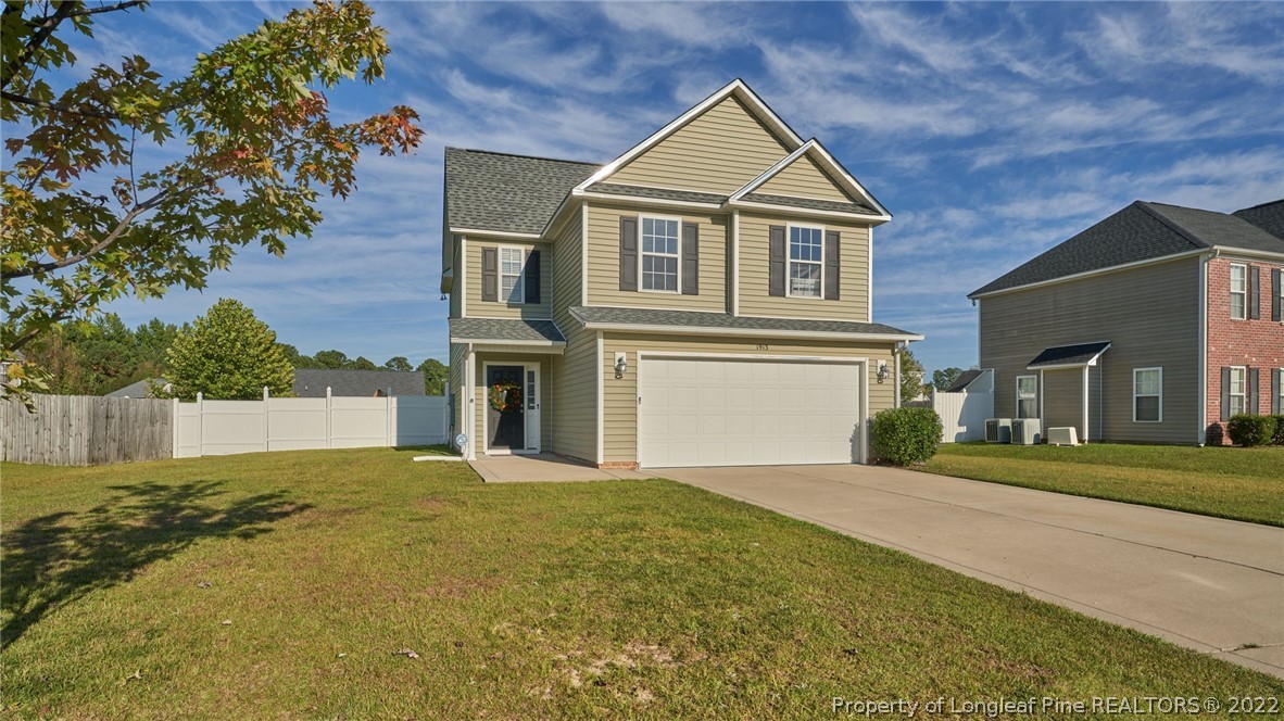 1913 Jenny Road Fayetteville, NC 28314 - Photo 2 of 38 a front view of a house with a yard and garage