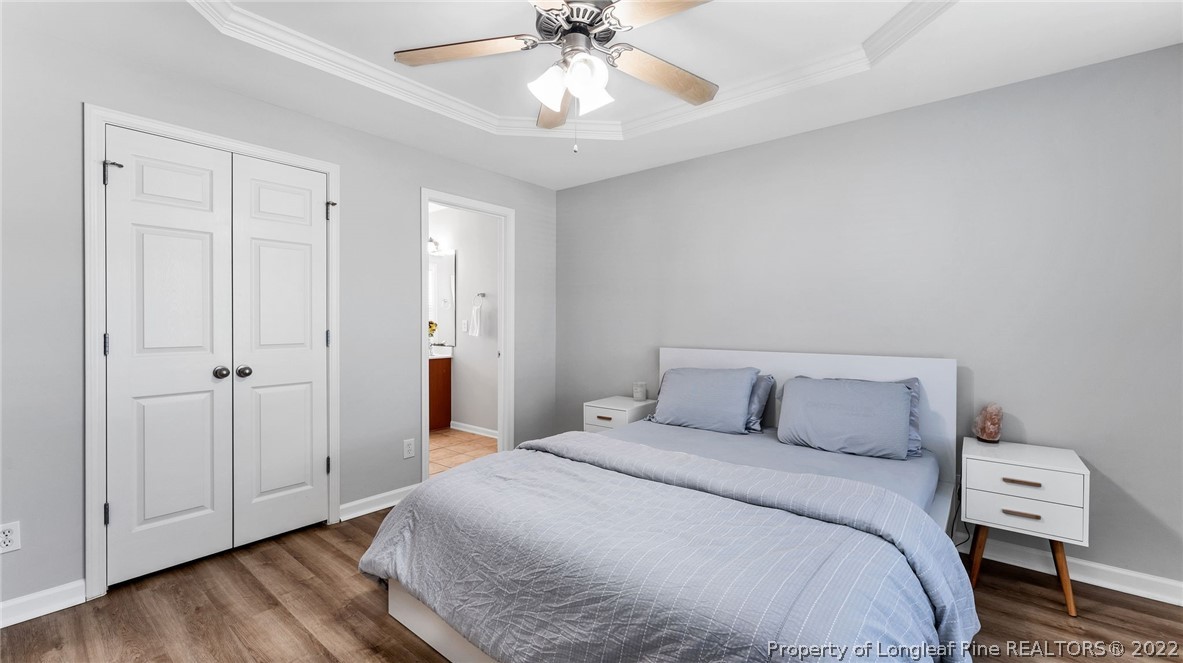 1913 Jenny Road Fayetteville, NC 28314 - Photo 22 of 38 a bedroom with a bed and a chandelier