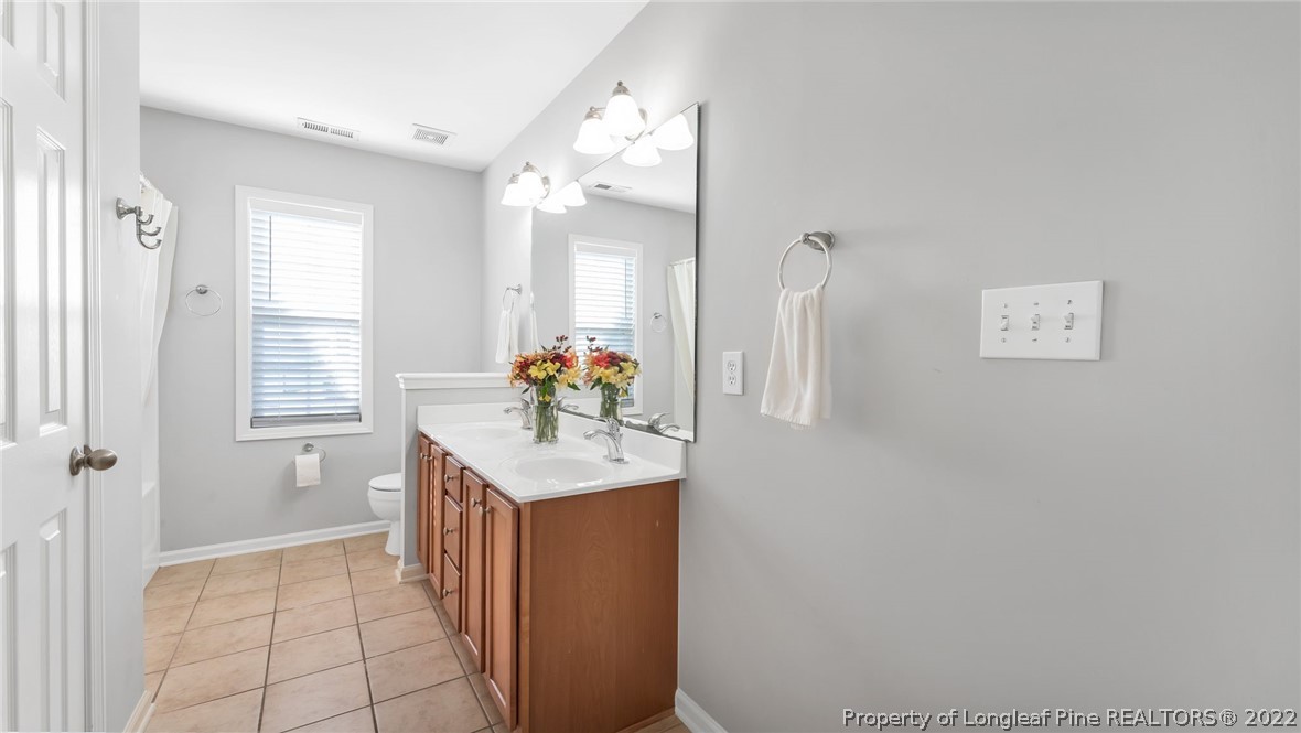 1913 Jenny Road Fayetteville, NC 28314 - Photo 23 of 38 a bathroom with a sink a vanity and a mirror