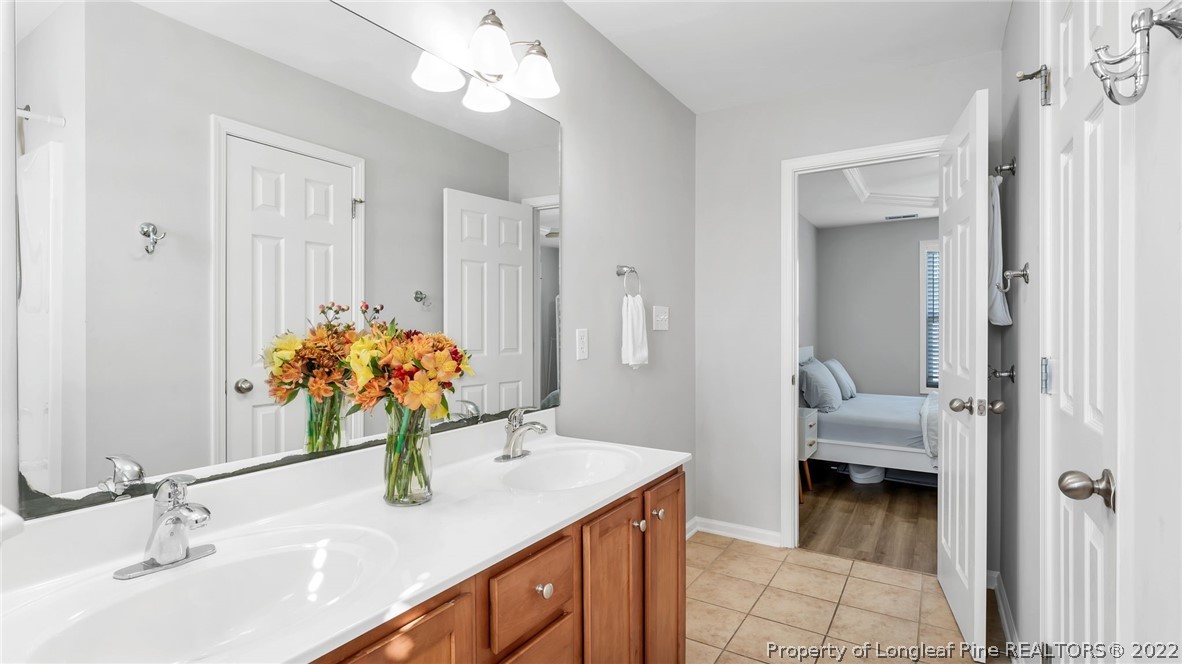 1913 Jenny Road Fayetteville, NC 28314 - Photo 25 of 38 a bathroom with a sink double vanity and a mirror