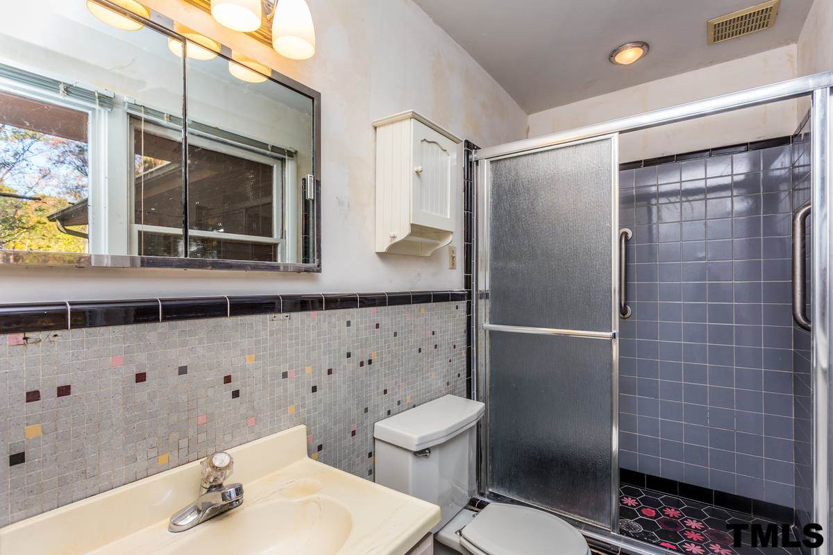 114 Longview Lake Drive Raleigh, NC 27610 - Photo 13 of 25 a bathroom with a sink a toilet and shower