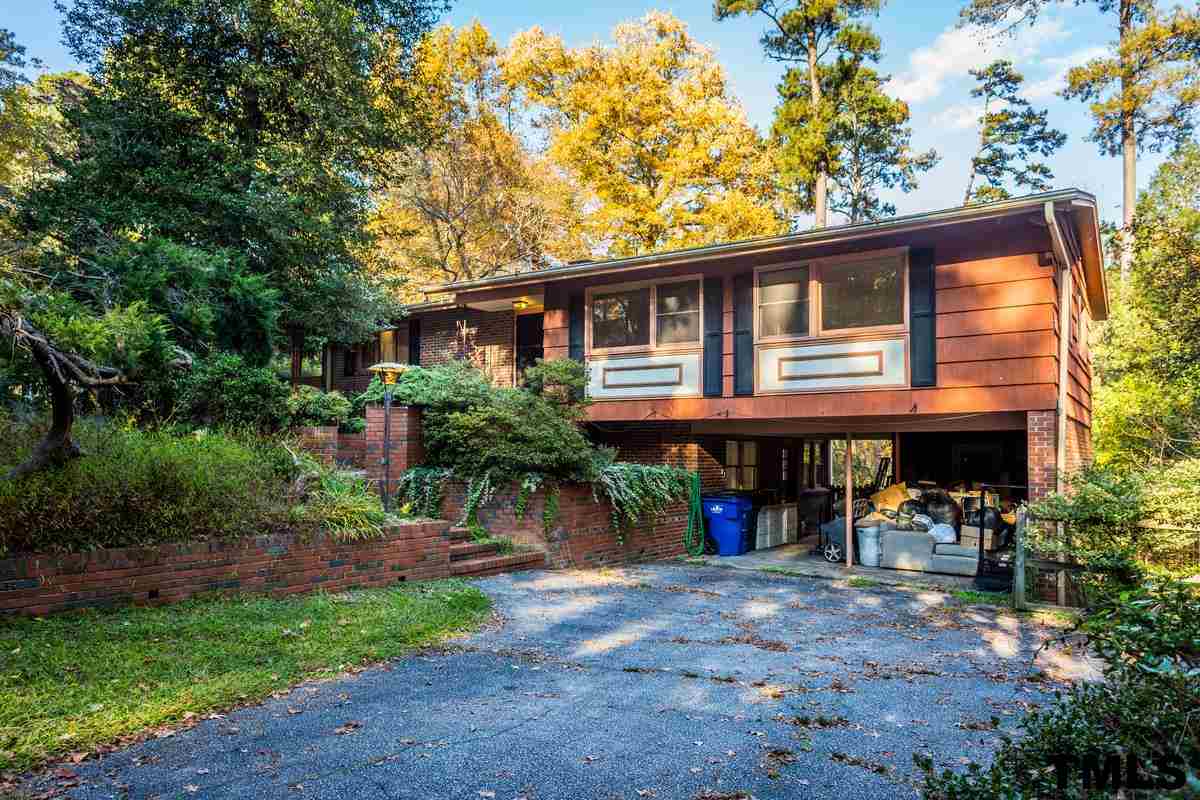 114 Longview Lake Drive Raleigh, NC 27610 - Photo 2 of 25 a front view of a house with garden and trees