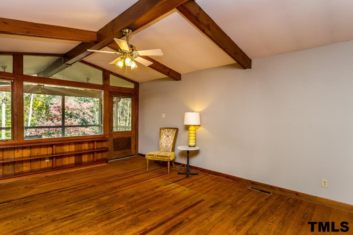 114 Longview Lake Drive Raleigh, NC 27610 - Photo 5 of 25 a view of an empty room with a window and wooden floor