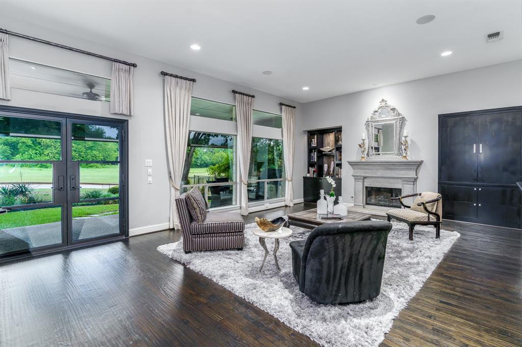 a living room with fireplace furniture and a large window