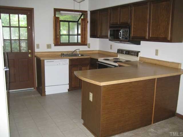 4536 New Hope Road Raleigh, NC 27604 - Photo 2 of 7 a kitchen with stainless steel appliances a stove a sink a microwave a refrigerator and cabinets