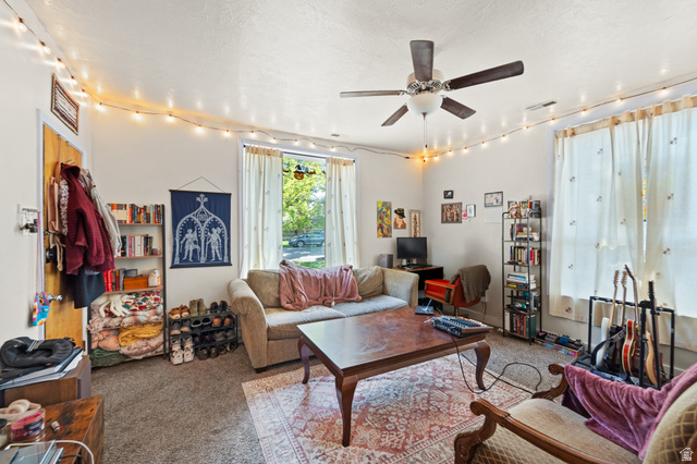 257 200 South Provo, UT 84606 - Photo 19 of 40 Carpeted living room featuring track lighting, ceiling fan, and a textured ceiling