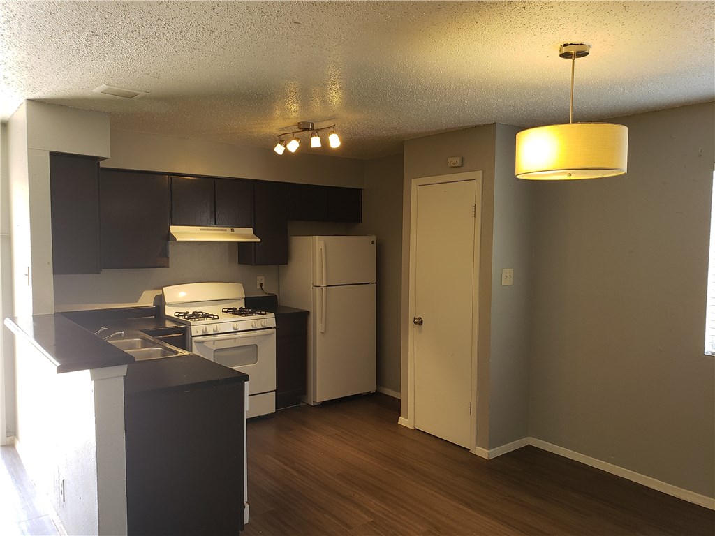 2304 Cedrick Cove, Unit B Austin, TX 78748 - Photo 3 of 7 a kitchen with stainless steel appliances a refrigerator a stove a sink and a hard wood floor