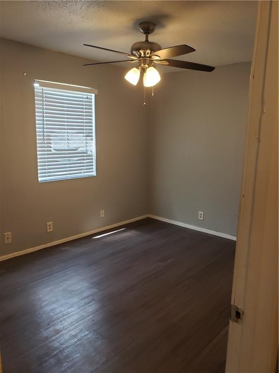 2304 Cedrick Cove, Unit B Austin, TX 78748 - Photo 6 of 7 wooden floor in an empty room with a window