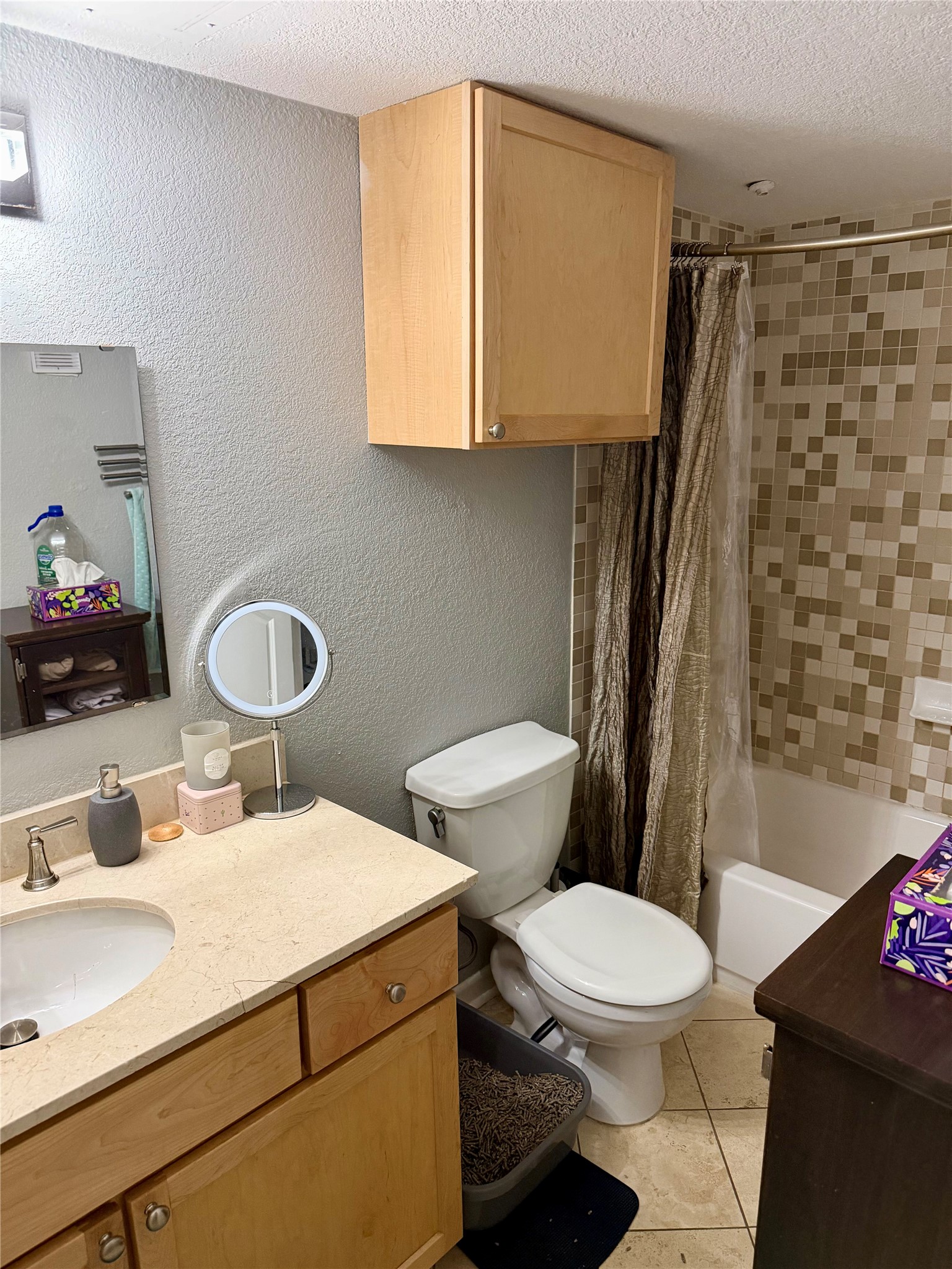 3204 Menchaca Road, Unit 204 Austin, TX 78704 - Photo 14 of 18 Bathroom featuring a textured wall, vanity, shower / tub combo, a textured ceiling, and light tile patterned floors
