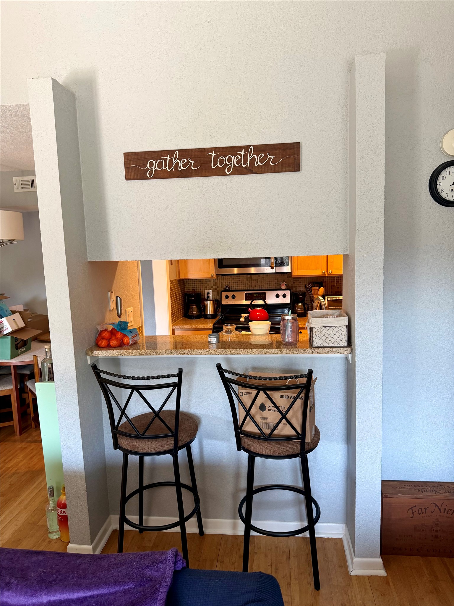 3204 Menchaca Road, Unit 204 Austin, TX 78704 - Photo 15 of 18 Kitchen featuring a kitchen breakfast bar, stainless steel appliances, light wood-style floors, and light stone counters