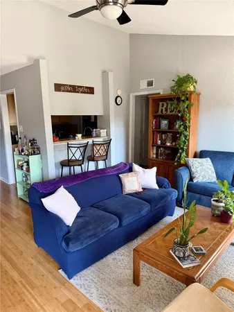 a living room with furniture and wooden floor