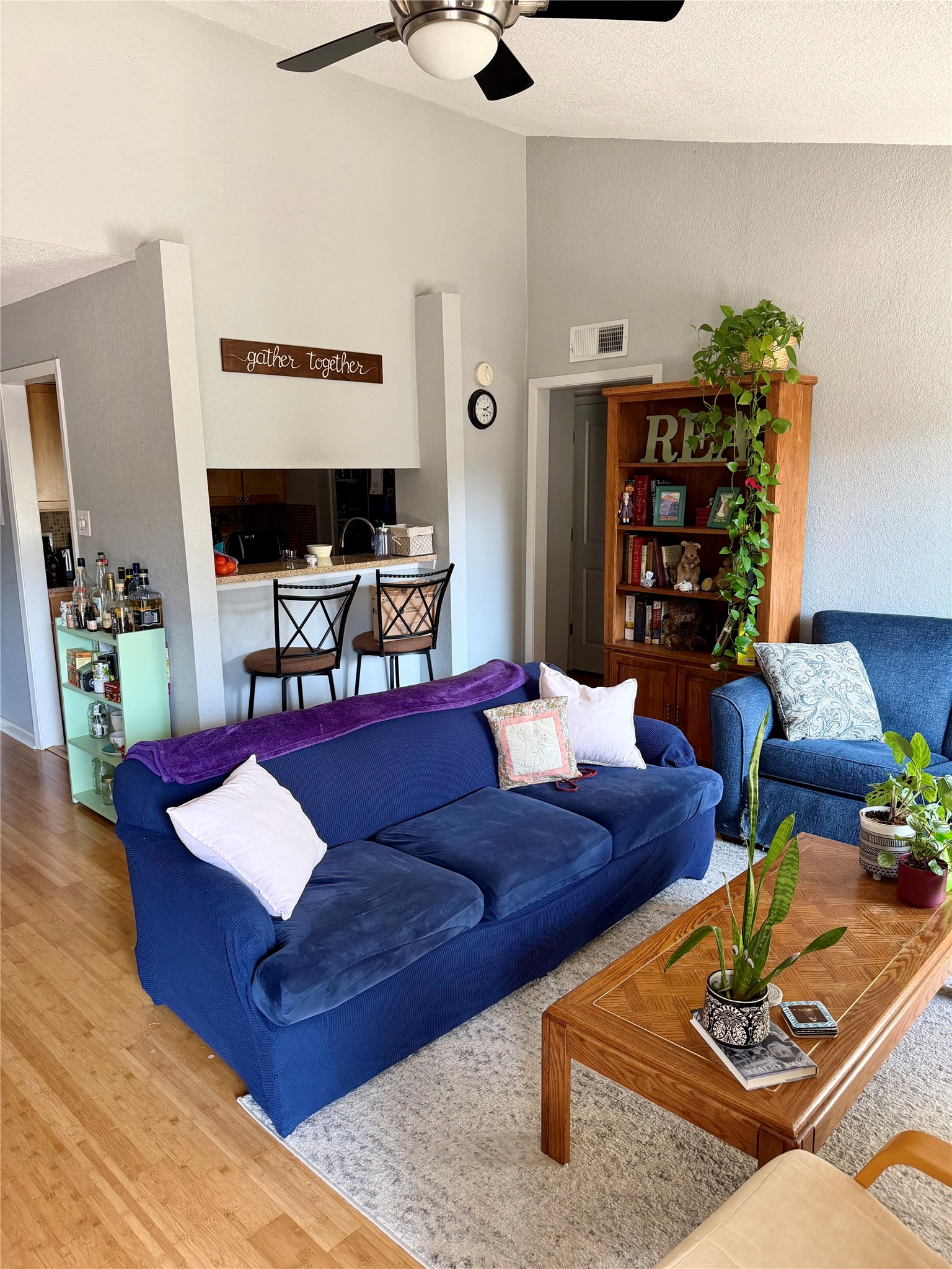 3204 Menchaca Road, Unit 204 Austin, TX 78704 - Photo 5 of 18 Living area featuring wood finished floors, ceiling fan, and a high ceiling