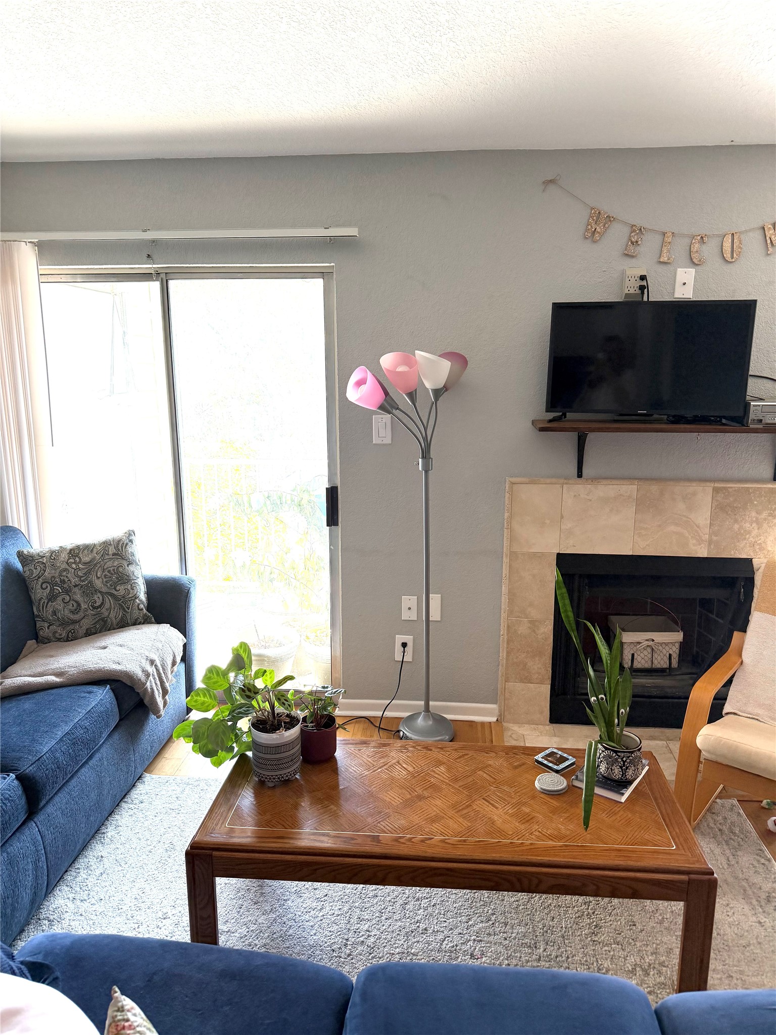 3204 Menchaca Road, Unit 204 Austin, TX 78704 - Photo 7 of 18 Living room featuring a tiled fireplace and baseboards
