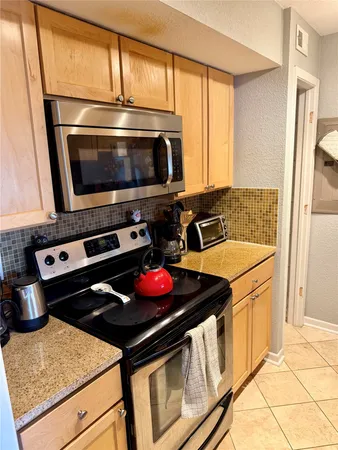 a kitchen with a stove and a microwave