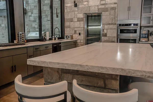 a spacious bathroom with a double vanity sink and a large mirror